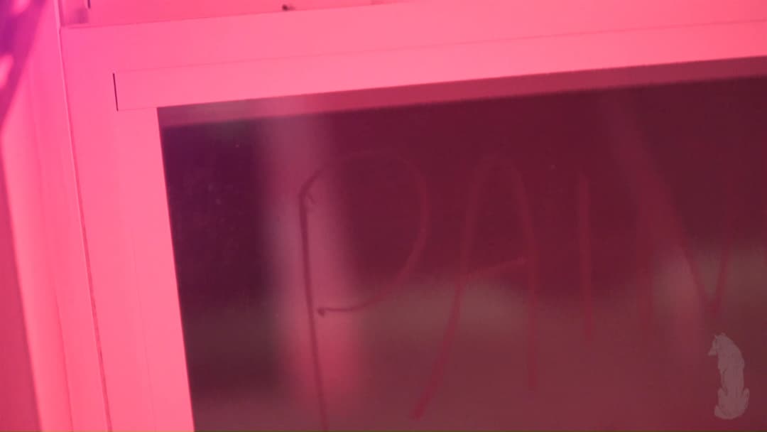 Pain music video still — datamoshed frame 001