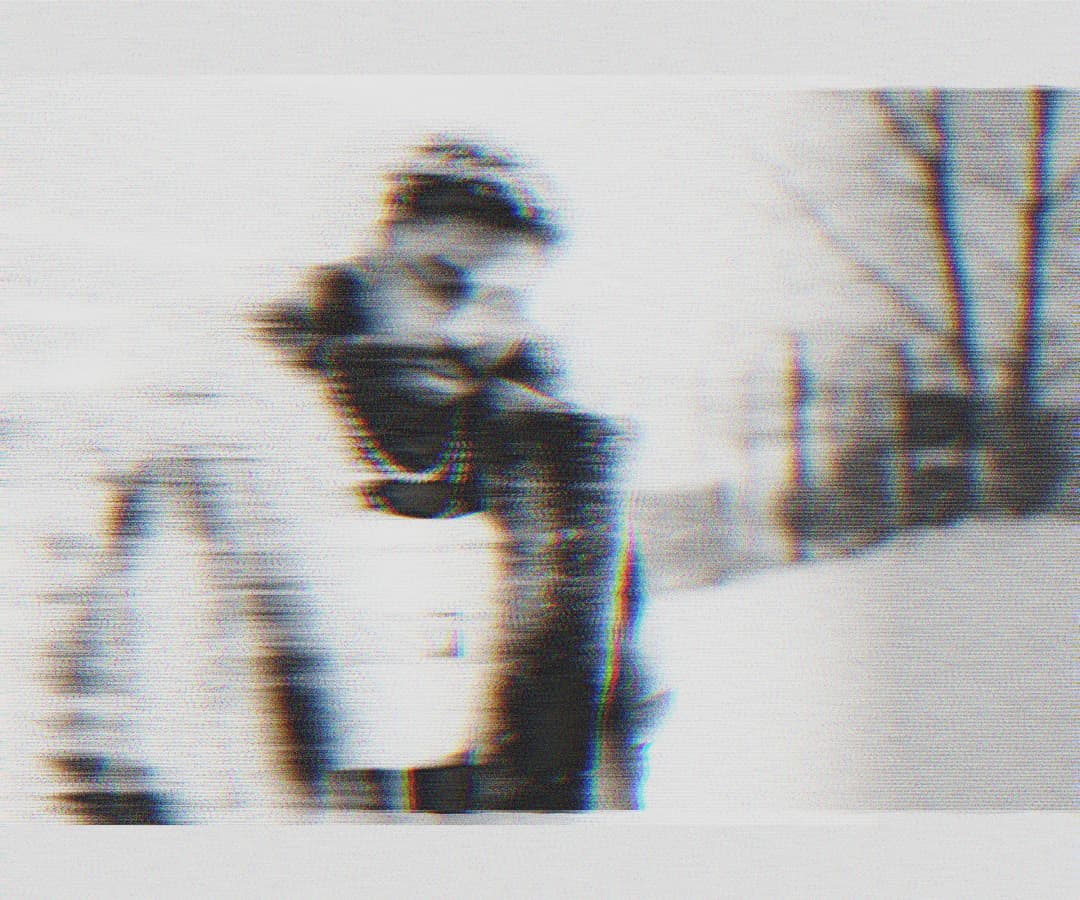 Alpha The Wolf hunched forward in a heavy coat outdoors in the snow, shot with extreme horizontal motion blur and chromatic aberration, figure fragmenting across the frame
